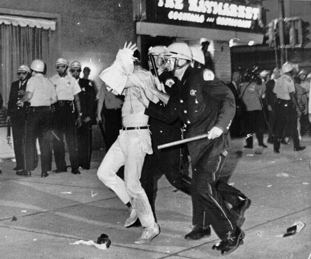 An Aug. 28, 1968 file photo shows a demonstrator with his hands on his head is led by Chicago Police down Michigan Ave. during a confrontation with police and National Guardsmen who battled demonstrators near the Conrad Hilton Hotel, headquarters for the Democratic National Convention