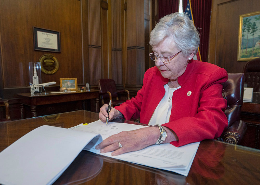 Alabama Governor Kay Ivey signs a bill that virtually outlaws abortion in the state on  May 15, 2019, in Montgomery, Alabama 