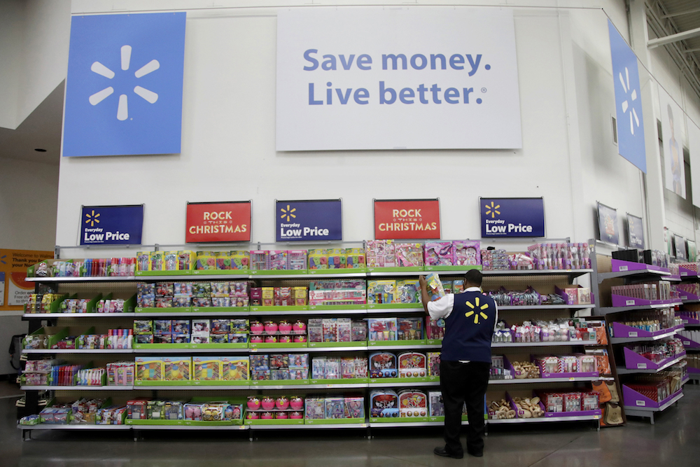 In this November 2017 photo, a Walmart employee scans items  at a store in North Bergen, New Jersey