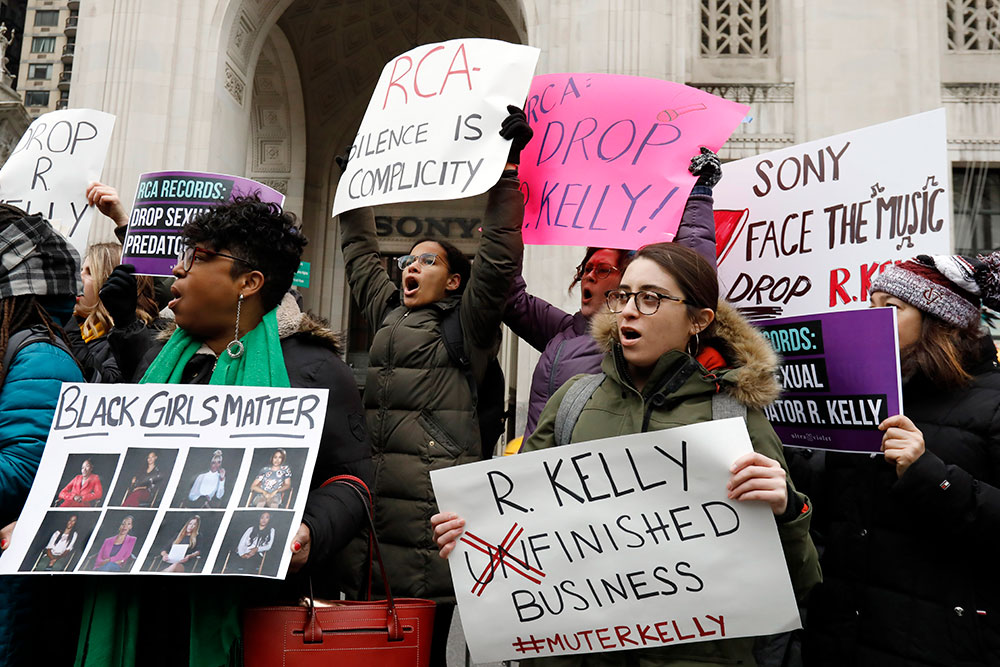 Demonstrators chant during an R. Kelly protest outside Sony headquarters in New York in January 2019, demanding Kelly be dropped from the record label