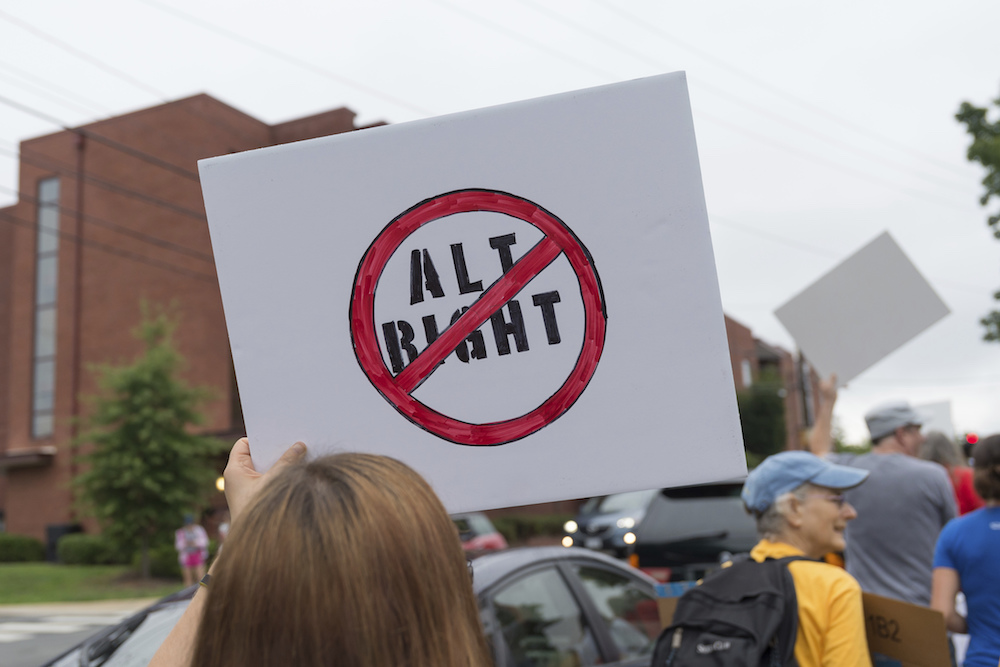 A woman holds a sign near Emancipation Park in downtown Charlottesville, Virginia, in August 2017 when white nationalists marched and counter-demonstrator Heather Heyer was killed
 