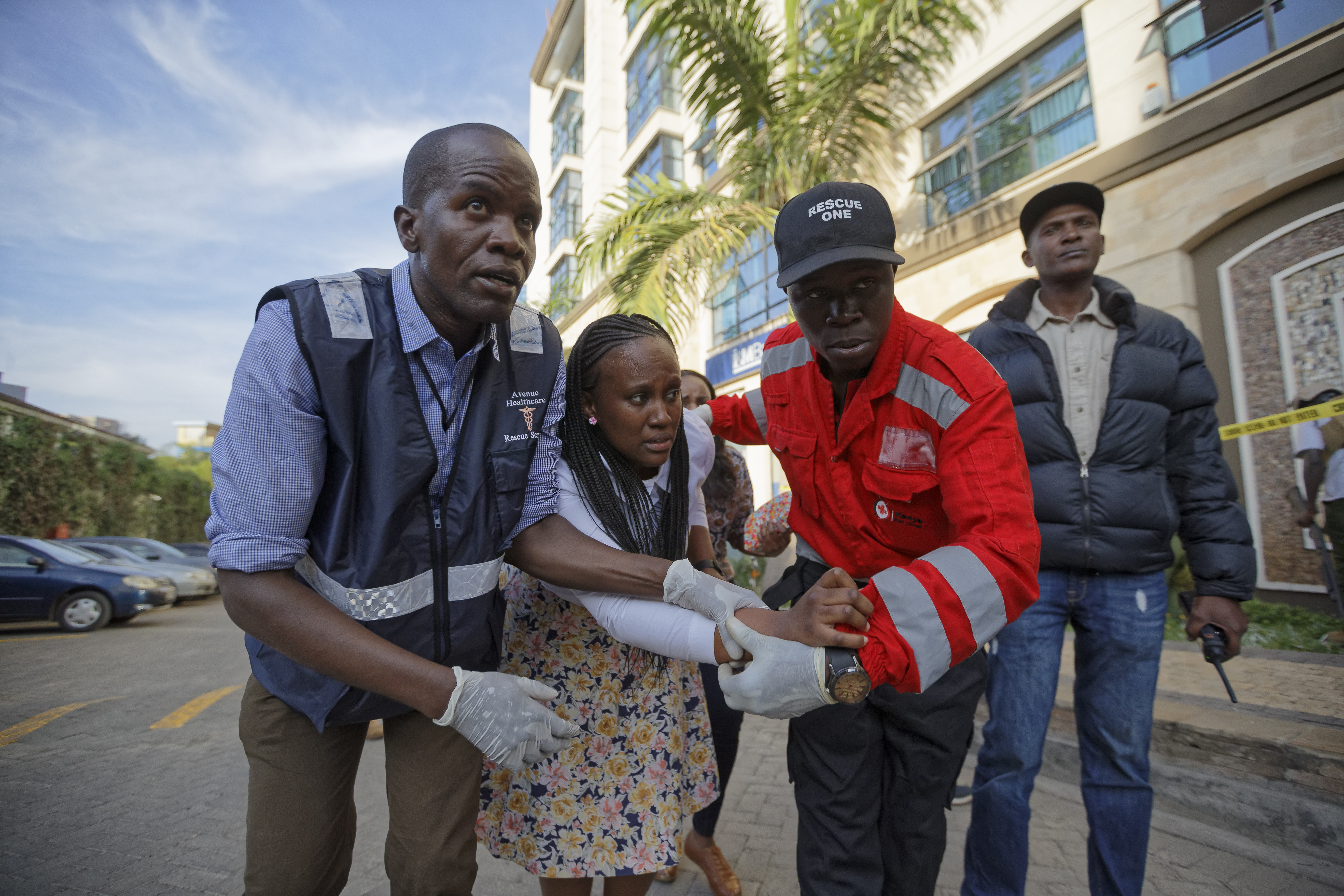 A civilian is helped by paramedics at a hotel complex in Nairobi, Kenya, where terrorists attacked an upscale hotel and office complex in January 2019, killing 21 people