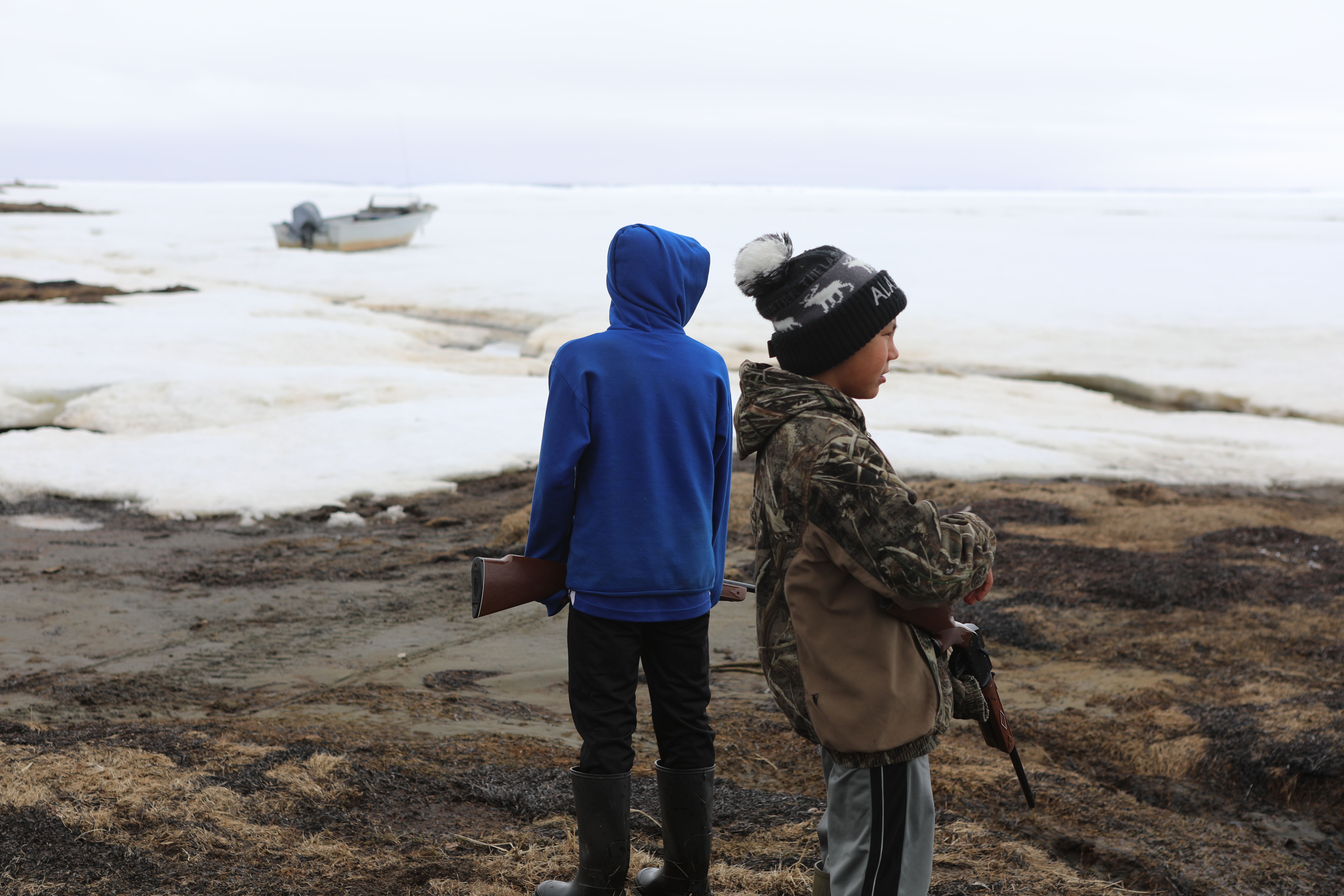 Young people hunt for small birds outside Shishmaref, Alaska, in the spring of 2019. They face uncertain futures because of the climate crisis