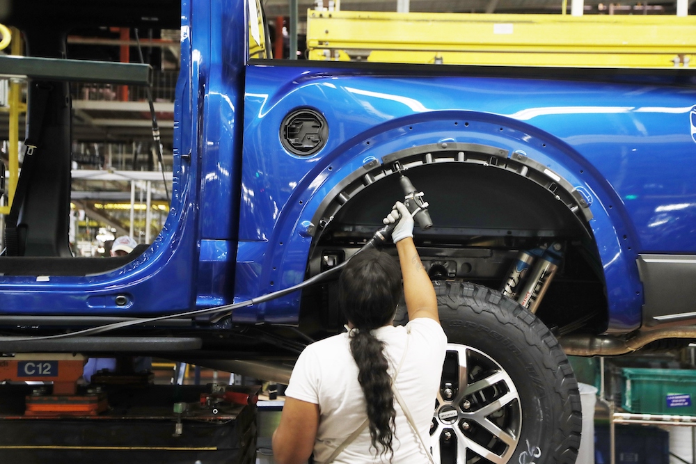 A United Auto Workers member works on a 2018 Ford F-150 truck being assembled at the Ford Rouge plant in Dearborn, Michigan in 2018