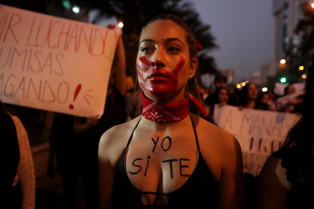 A woman attends a rally against gender violence in Santiago, Chile in 2018