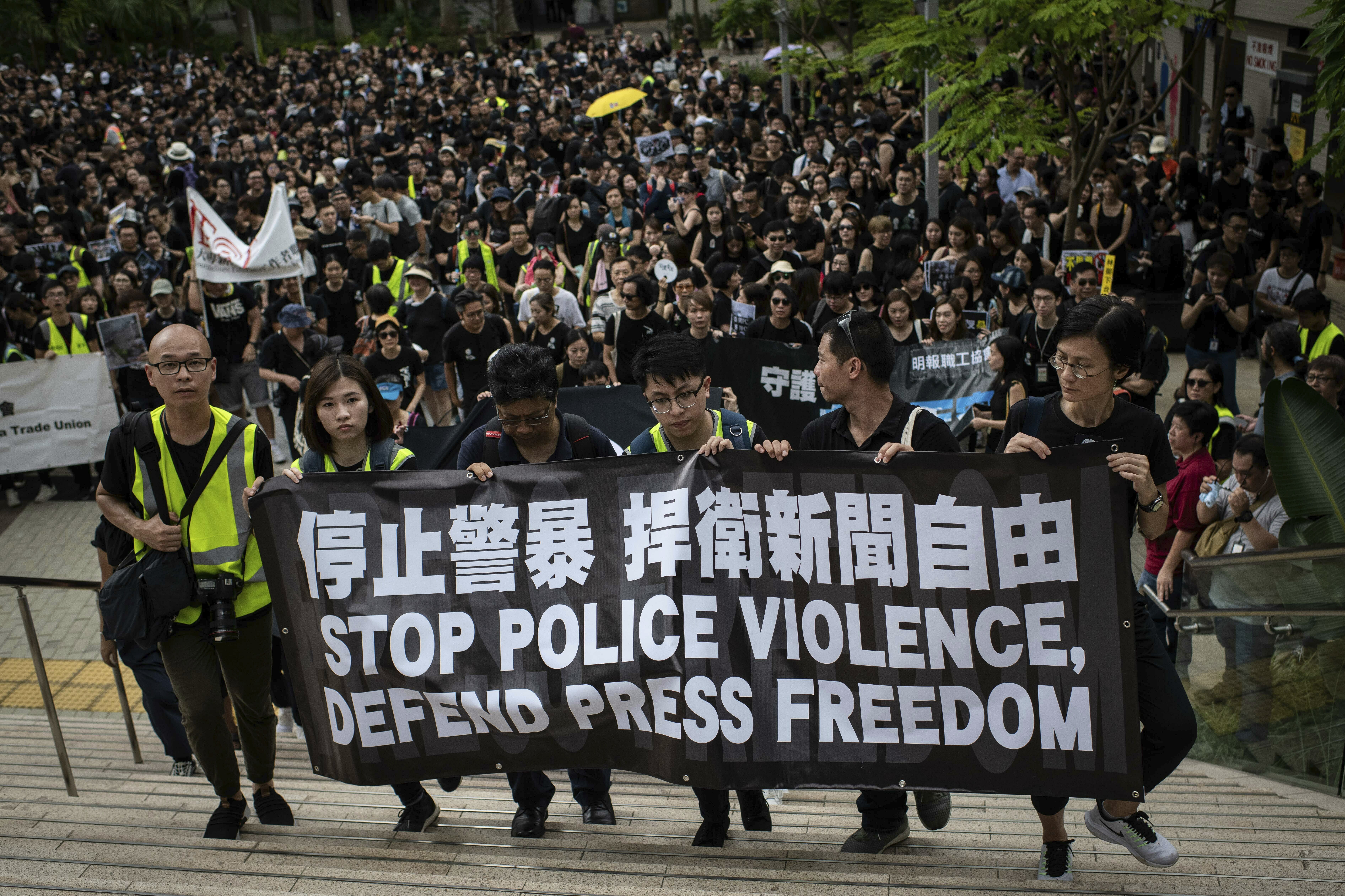 Protesters hold a banner during a march, organized by media groups and journalist trade unions, calling for press freedom amidst the ongoing protests in Hong Kong. In addition to political pressure, journalists have increasingly been the targets of physical and verbal assaults from police