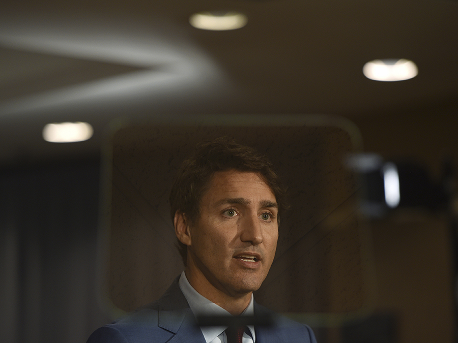 Canadian Prime Minister Justin Trudeau, framed by a teleprompter, is facing a furor after a 2001 photo of him in brownface surfaced and two other similar incidents came to light. He is up for re-election October 21.