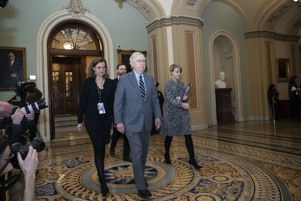Senate Majority Leader Mitch McConnell departs the Senate chamber after hearing arguments in the impeachment trial of President Donald Trump.