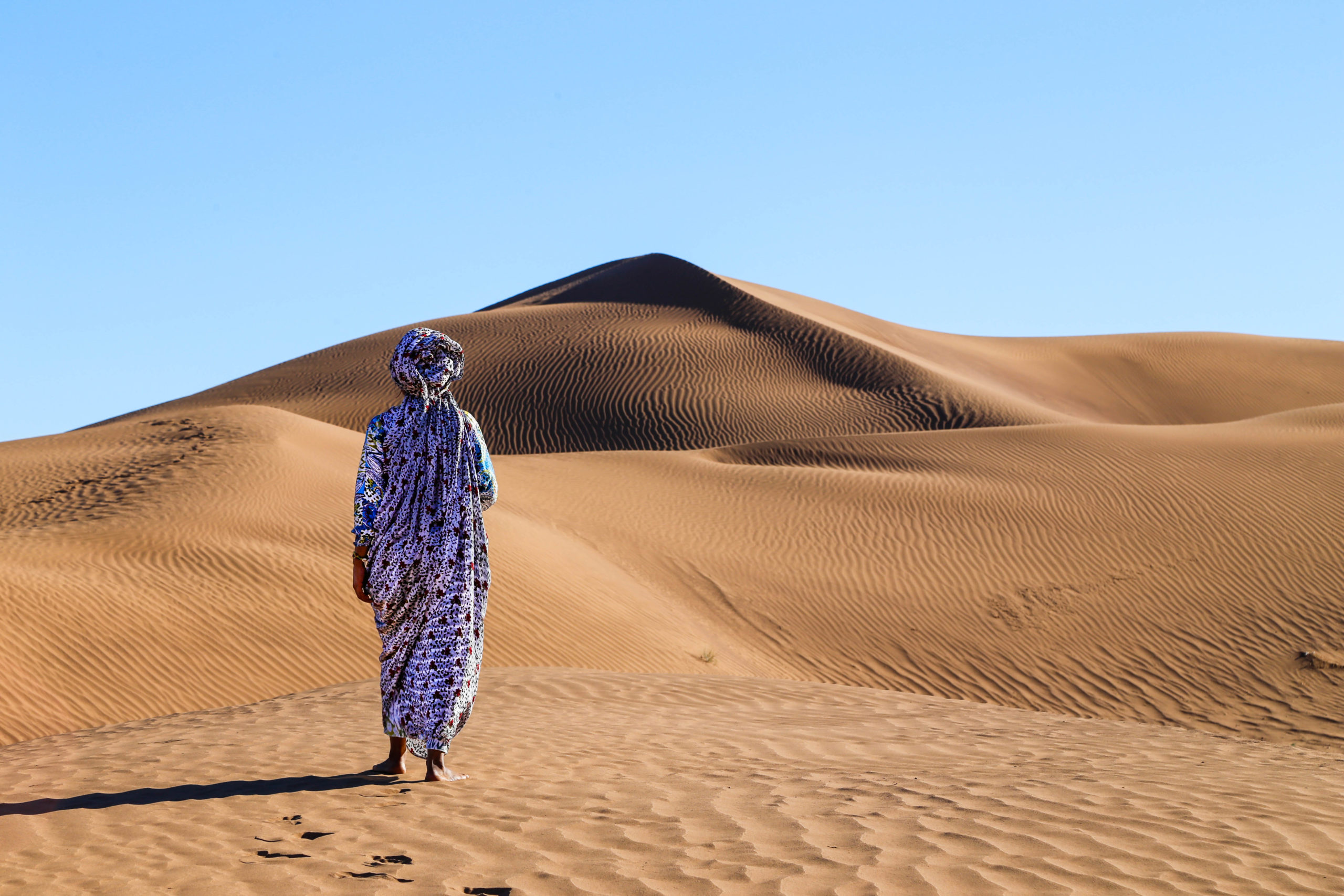 Chaimae Radouani, who is featured in the VR film “The Disappearing Oasis” walks in the desert.