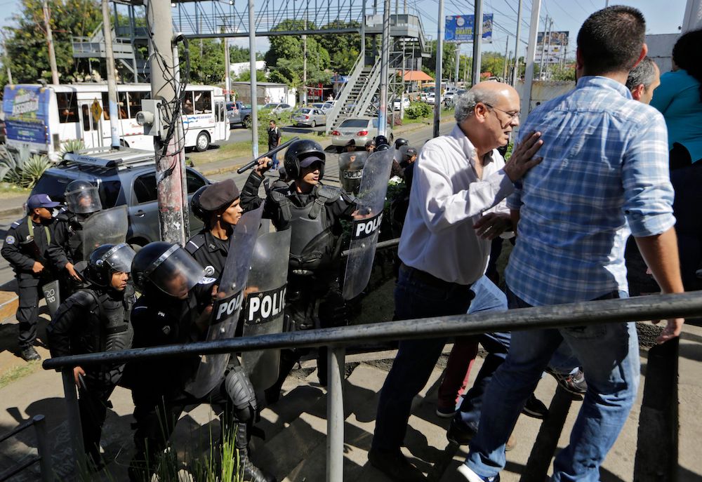 Riot police, approach a Managua, Nicaragua, police station to speak to officials in December 2018.