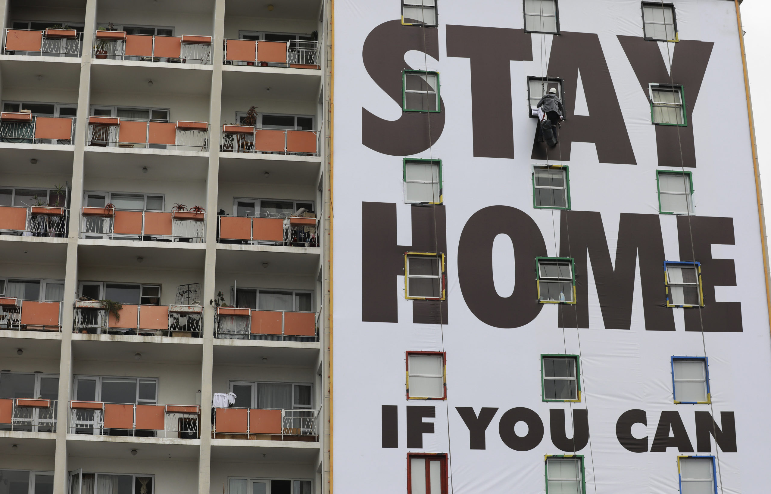 A billboard is installed on an apartment building in Cape Town, South Africa as the country went under a national lockdown due to the coronavirus pandemic