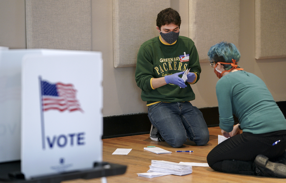 Benjamin Olneck-Brown, left, and Laura Muller organizing absentee ballots at the Wil-Mar Neighborhood Center in Madison during Wisconsin's primary elections in April