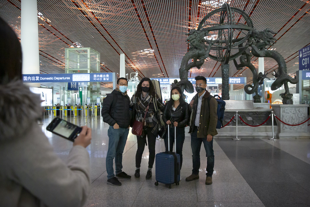 Wall Street Journal China bureau chief Jonathan Cheng, left, poses for a photo with Journal reporters (from left) Julie Wernau, Stephanie Yang, and Stu Woo before their departure at Beijing Capital International Airport in March 2020. They were among the more than a dozen American journalists expelled from China that month