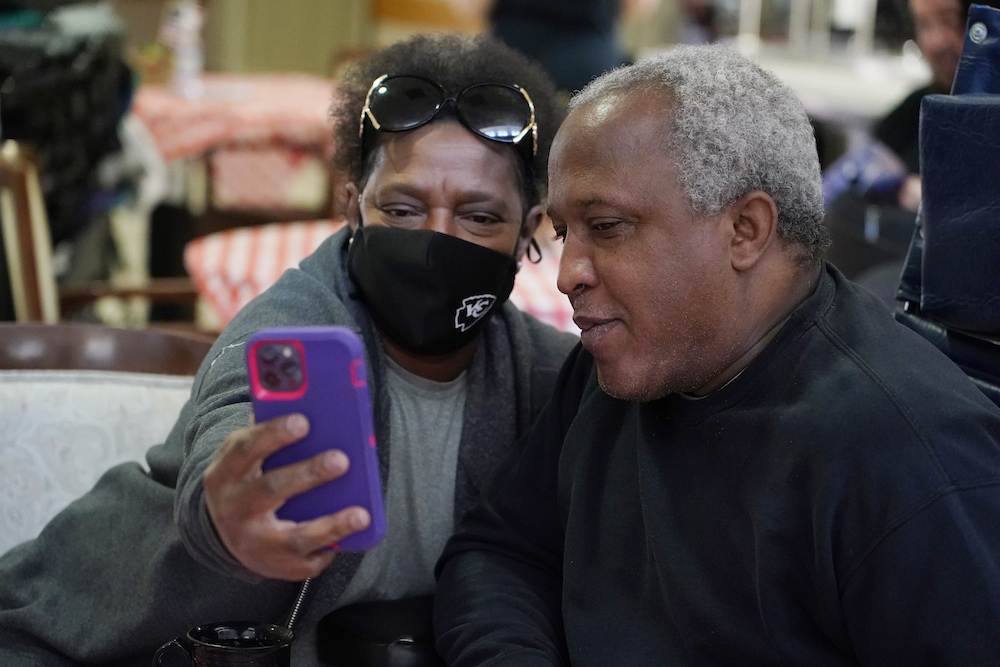 Craig Rawls, an Army National Guardsman, right, poses with his wife Chris Rawls for a "selfie," with only a face mask as a protective garment at the Mississippi State Veterans Home in Collins, Miss., as part of Operation "Family Reunion," on April 1, 2021.