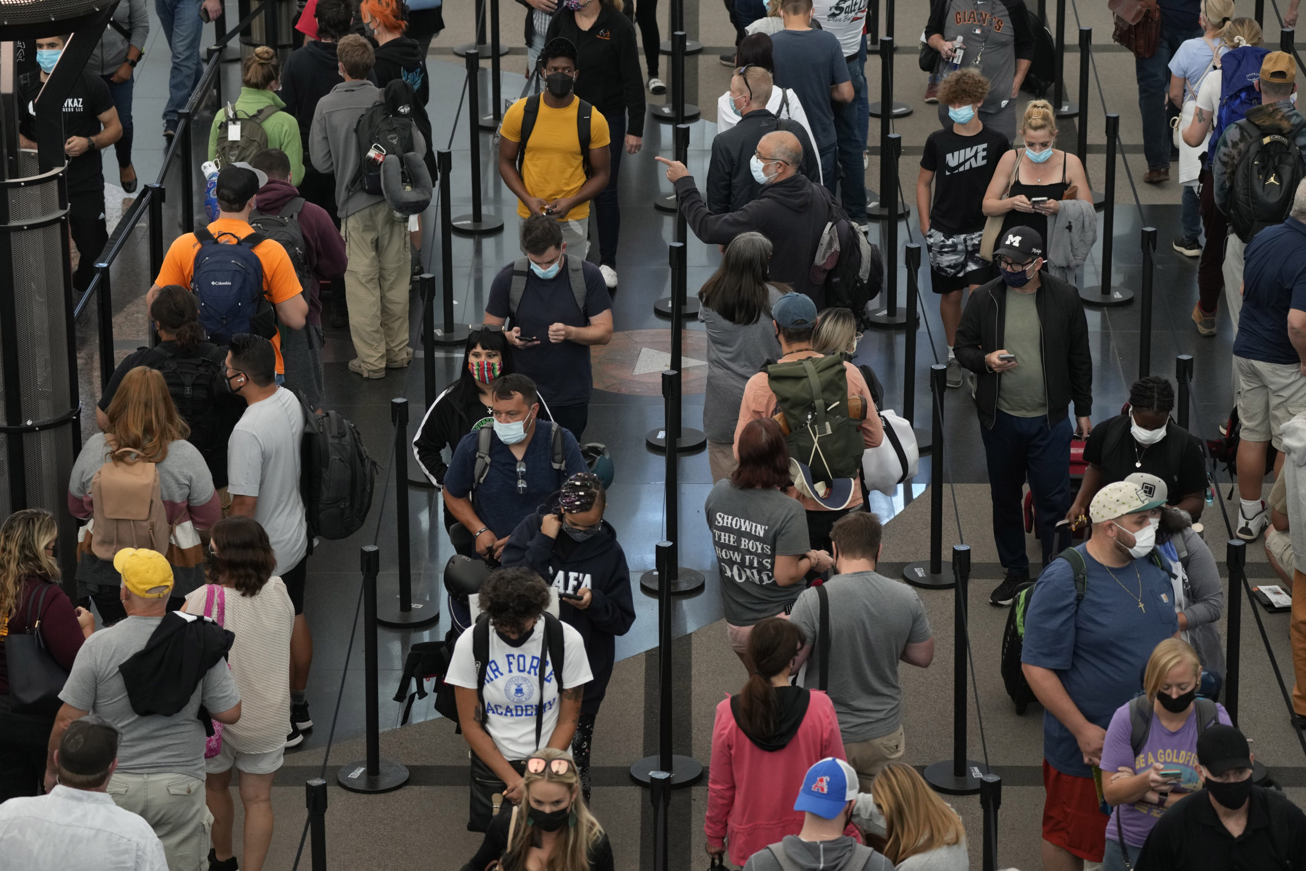 Travelers queue up at the north security checkpoint in Denver International Airport on Sept. 14, 2021, in Denver