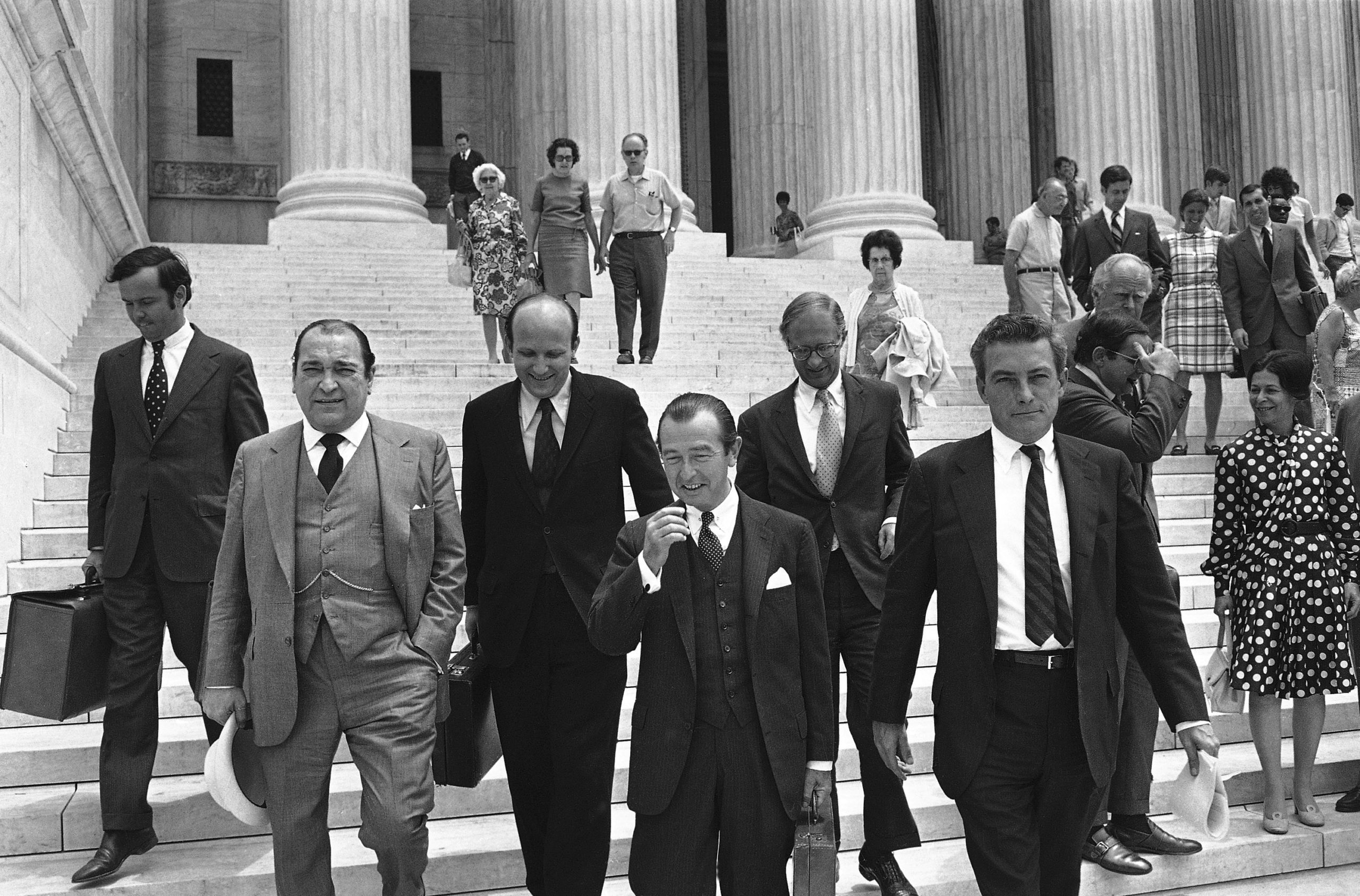 Six Attorneys for The New York Times walk down the steps of the Supreme Court side by side