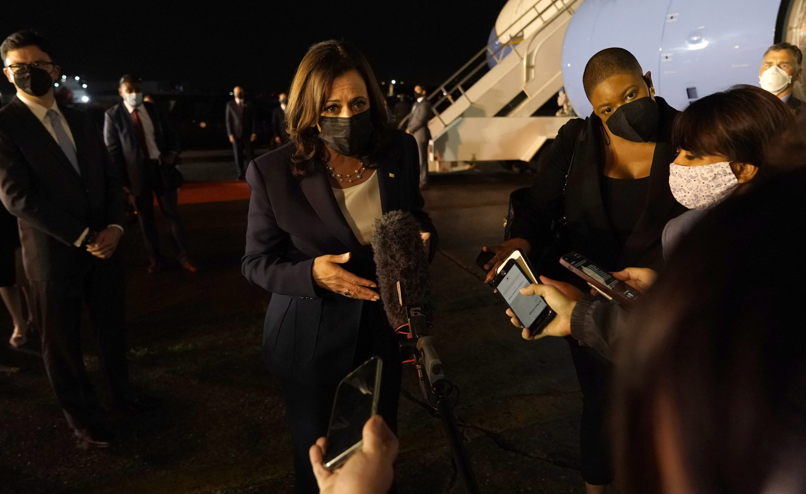 Vice President Kamala Harris talks to the press gathered under the wing of Air Force Two as she prepares to depart for Mexico from Guatemala's Air Force Central Command in June 2021