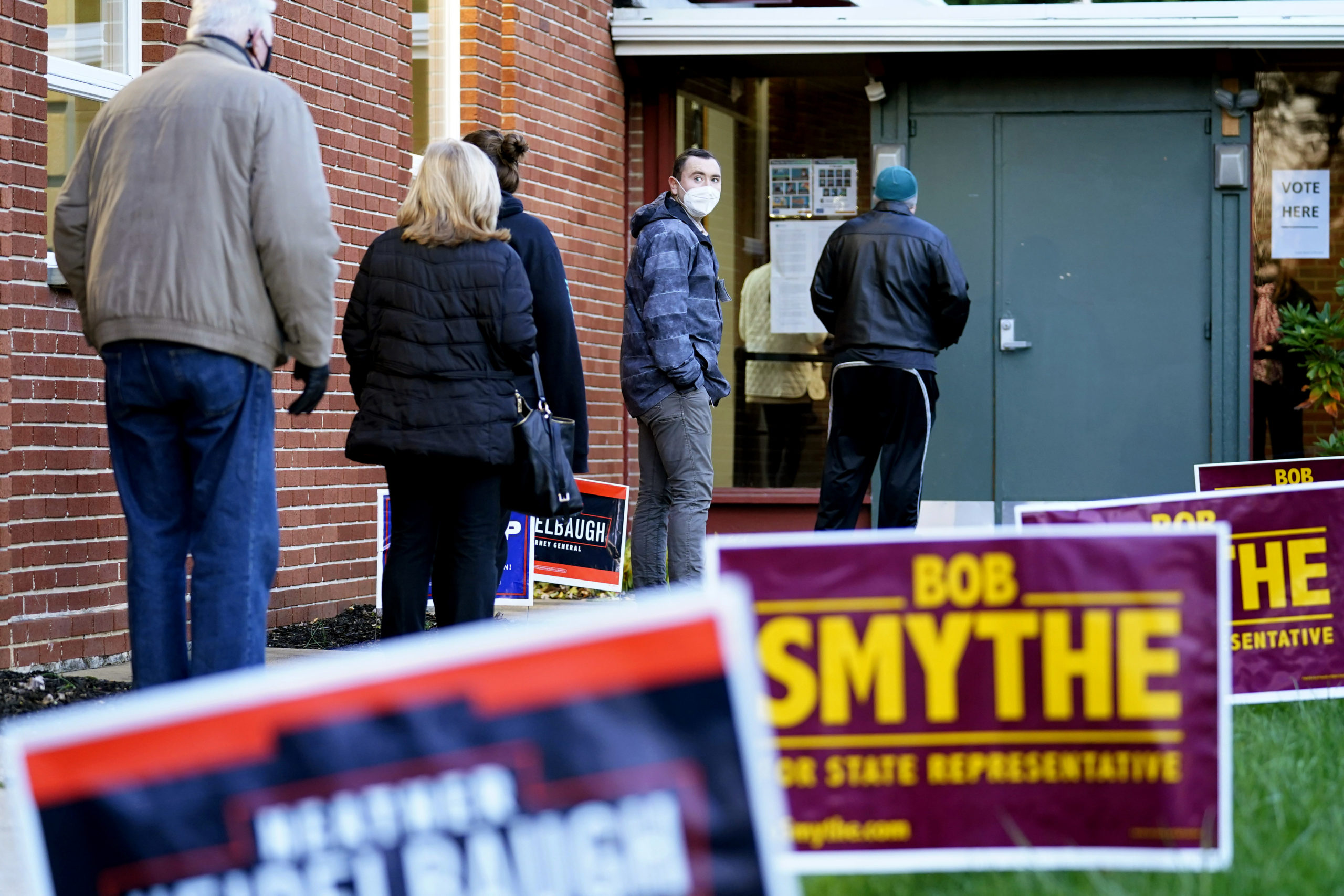 People line up outside a polling place to vote in the 2020 general election in the United States in Springfield, Pa. 