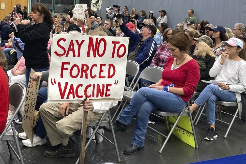 Audience members gather during a meeting of New Hampshire's Executive Council in Concord, N.H. on Oct. 13, 2021. Misinformation about the pandemic has played a key role in fueling the public health crisis