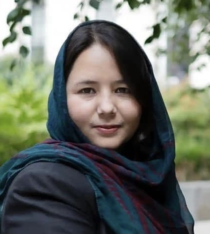 Photo of Afghan journalist Zahra Joya, founder of Rukhshana Media, sitting in a garden