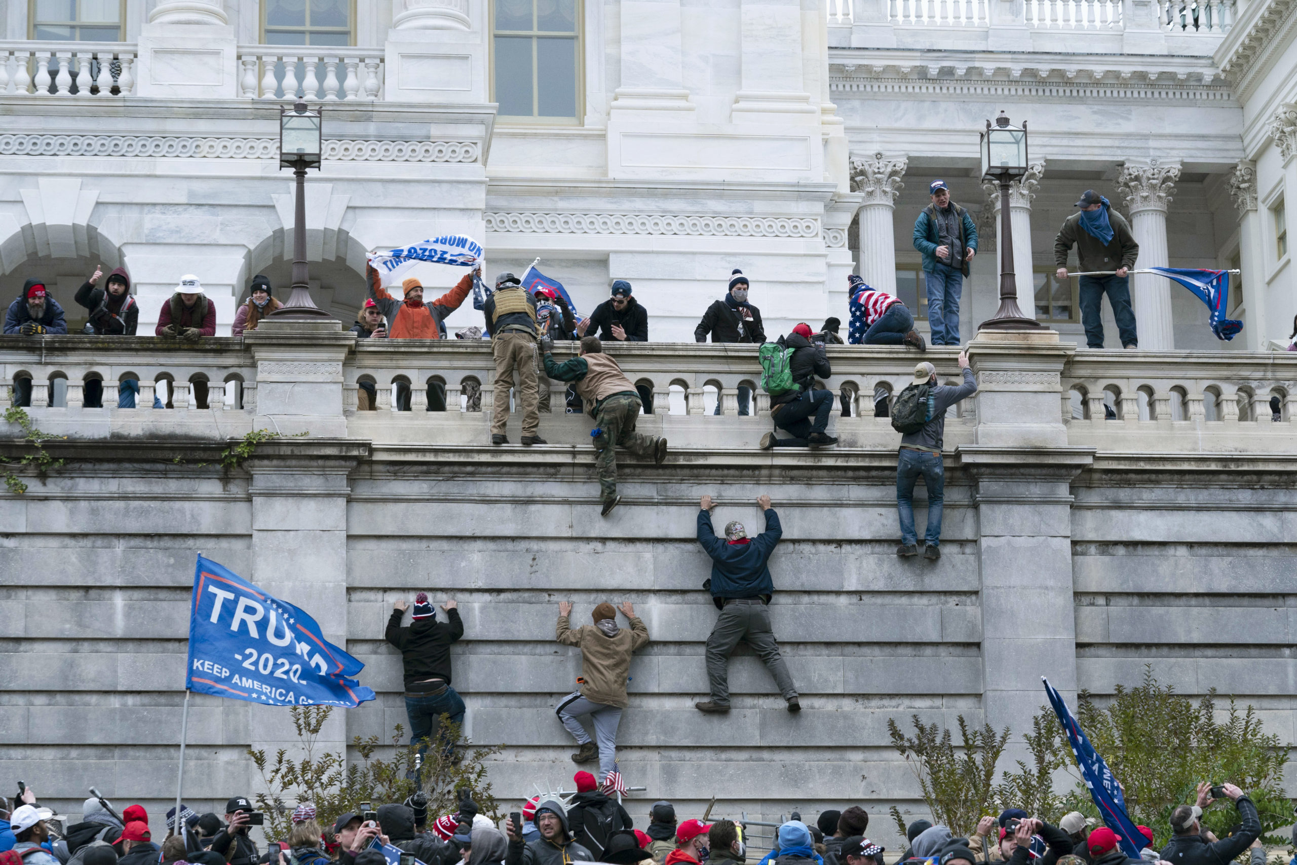 Violent insurrectionists loyal to President Donald Trump scale the west wall of the the U.S. Capitol in Washington on Jan. 6, 2021 