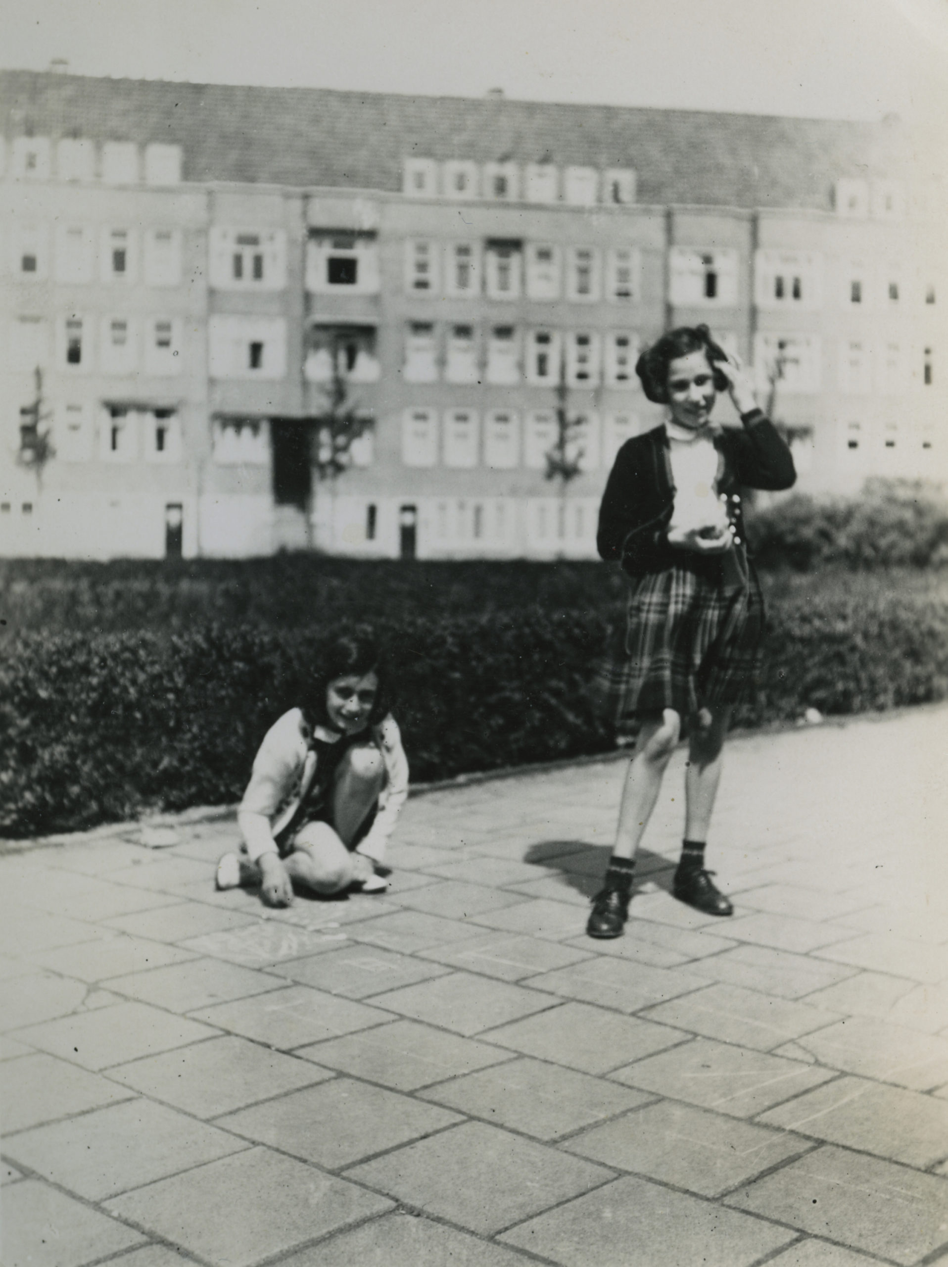 Anne Frank and her friend Hannah Pick- Goslar playing at the Merwedeplein in Amsterdam, May 1940