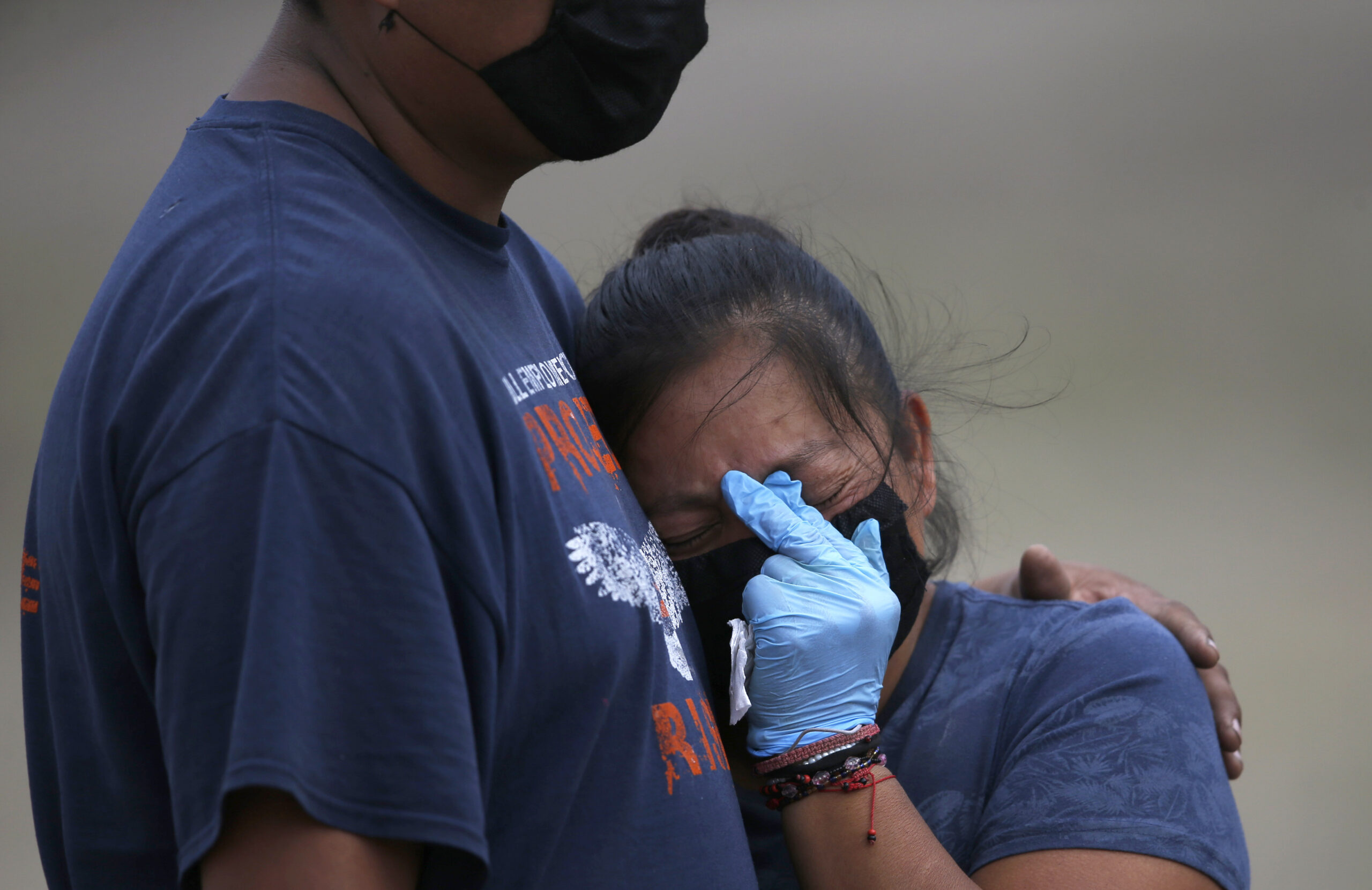 A couple mourns during the burial of their loved one at the newly constructed Valle de Chalco Municipal Cemetery, built to accommodate the rise in deaths amid the pandemic, on the outskirts of Mexico City, May 2020