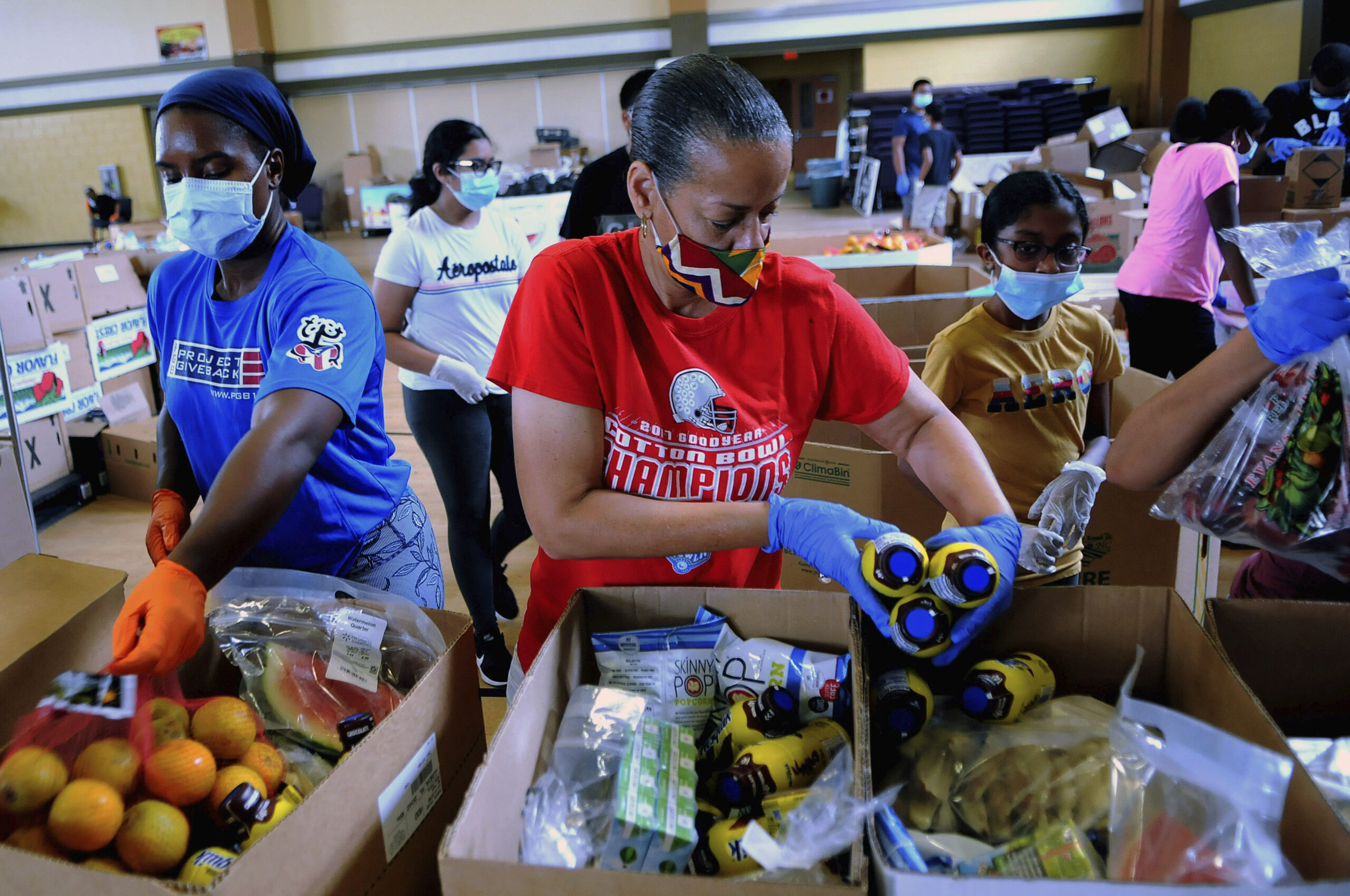 Volunteers prepare boxes of food from the Second Harvest Food Bank of Central Florida during a drive-through food distribution event, July 2020. Mutual aid efforts during the pandemic served as inspiration for Alissa Quart, NF '10, while writing her book "Bootstrapped"