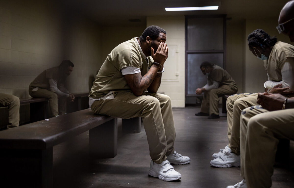 Michael Laster waits with other detainees in a holding cell in the basement of the Leighton Criminal Courts Building before scheduled court appearances Monday, Oct. 3, 2022 after walking through tunnels from Cook County Jail.