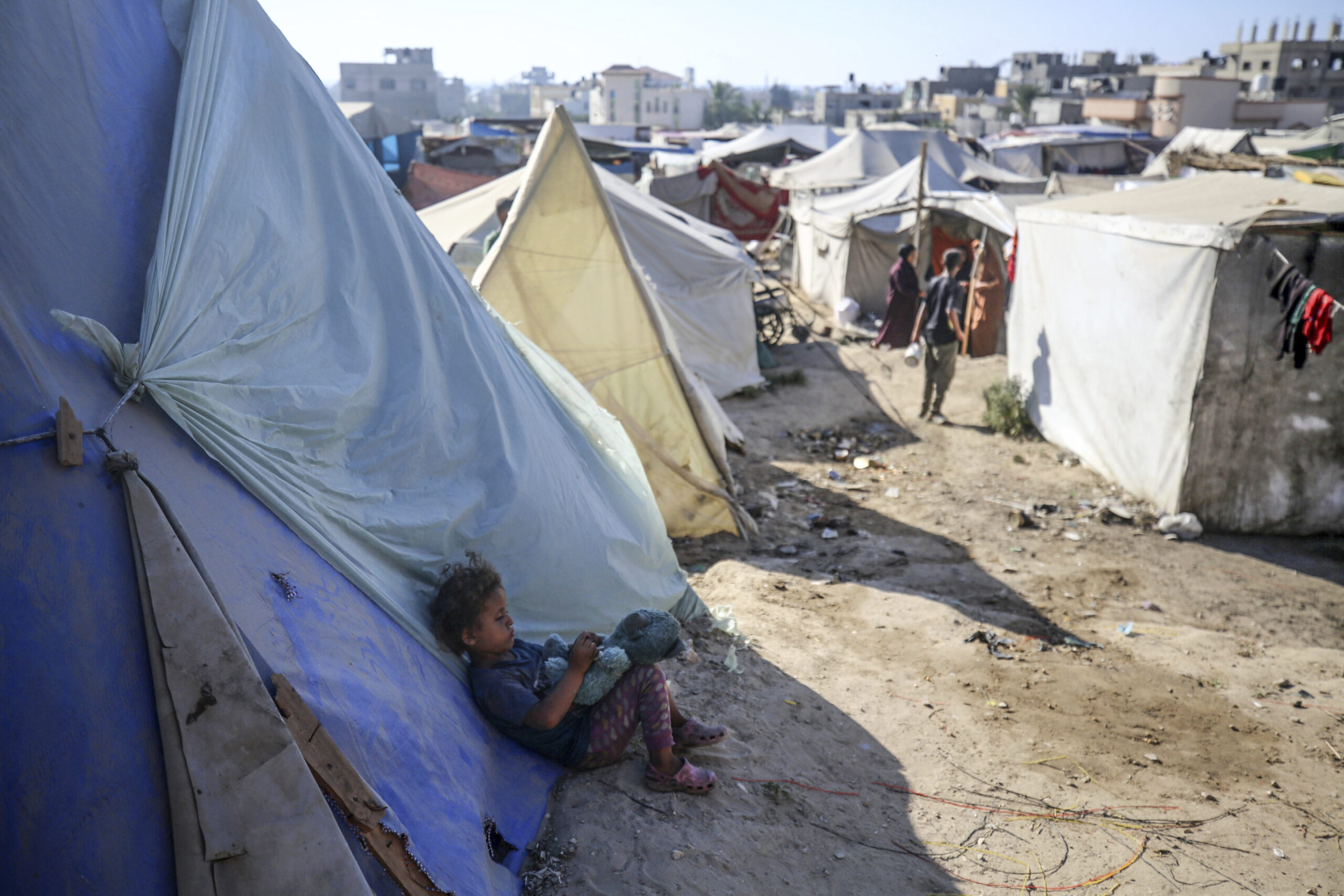 A Palestinian girl sits outside her tent in a displacement camp during a heat wave in Deir al-Balah in the Gaza Strip on June 11. The BBC Lifeline Service has been providing critical information to Gazans on military movements, humanitarian efforts, the availability of medical services, and incoming aid.